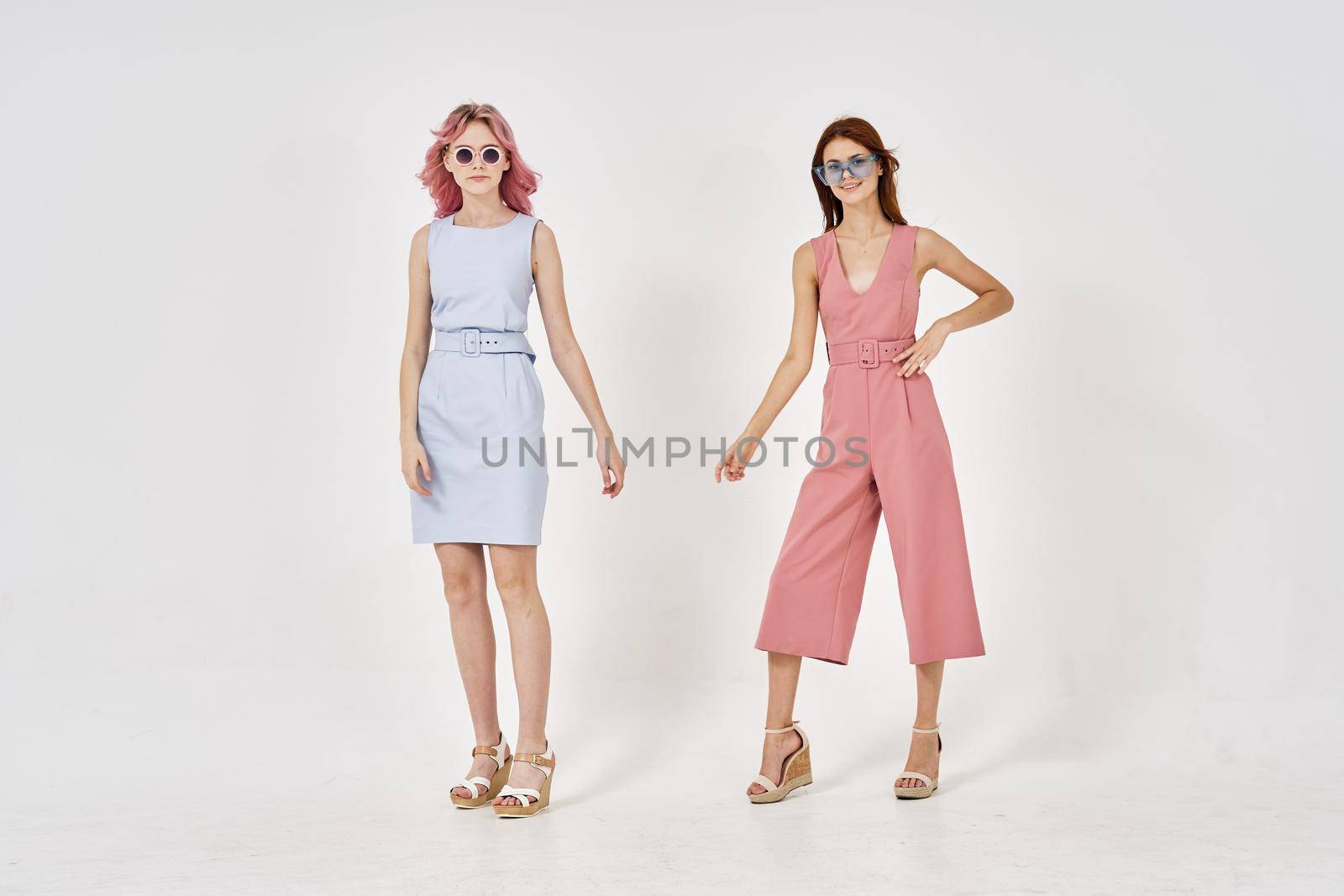 two girlfriends stand side by side fashion clothing glamor posing by Vichizh