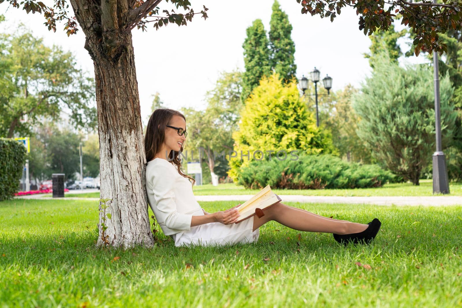 Beautiful young woman study with notepad in park