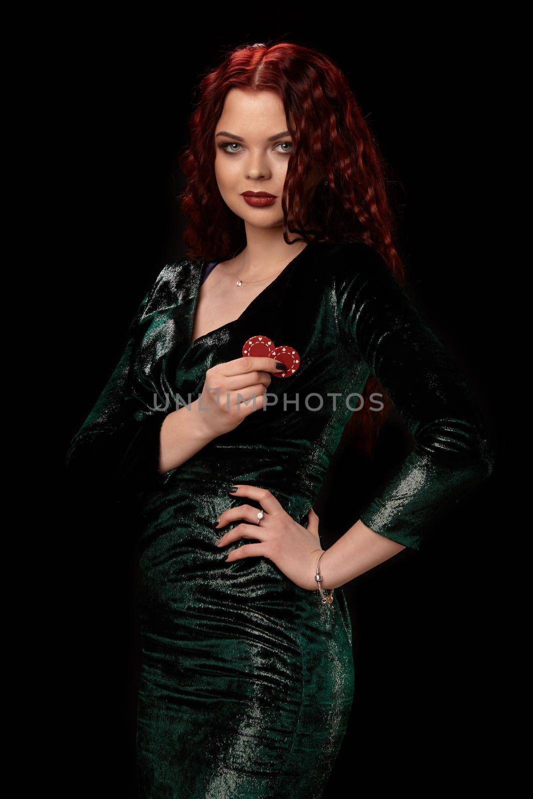 Young beautiful redheaded woman with chips in her hands over black. Win casino holdem poker slots