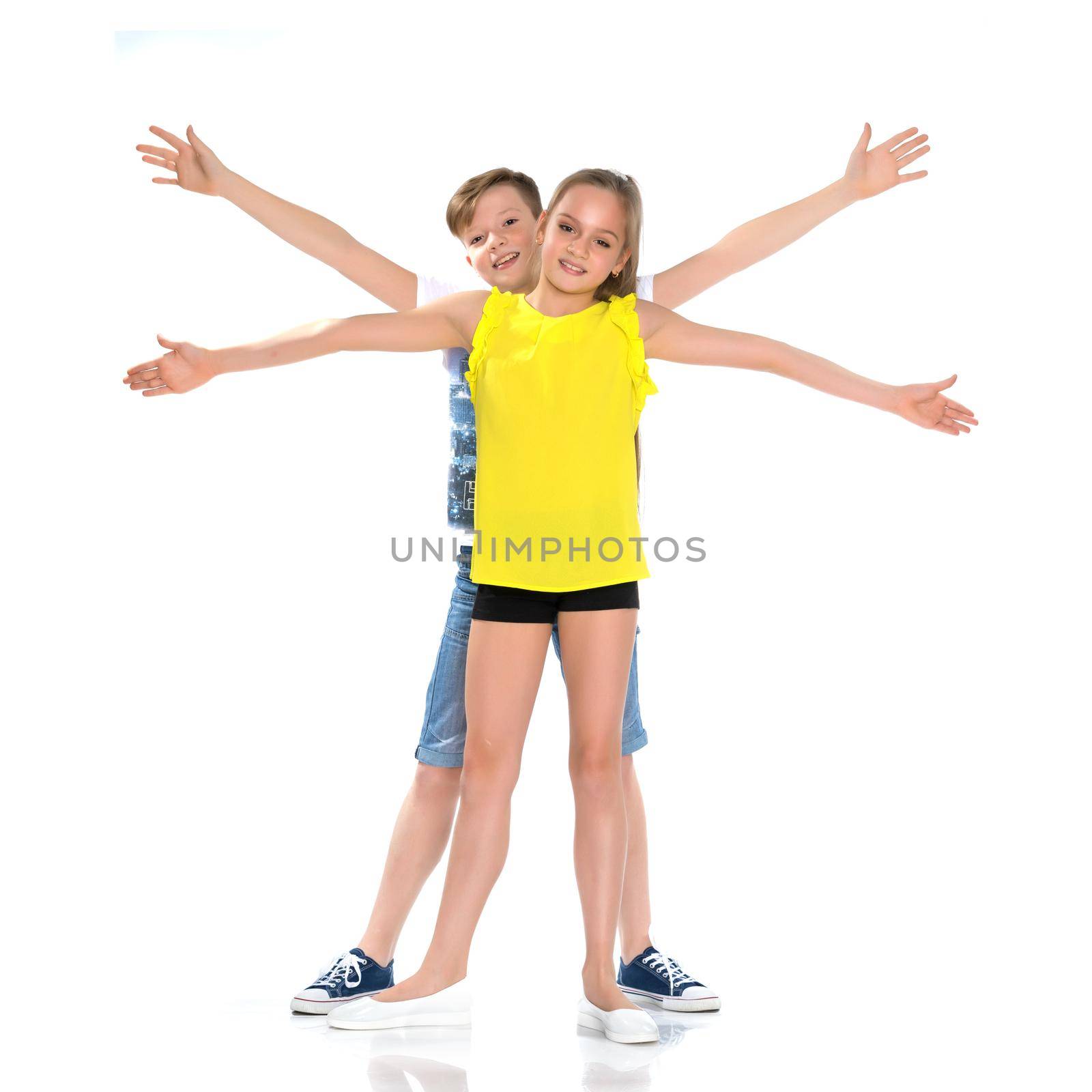 Teens brother and sister. The concept of a happy childhood, beauty, people, fashion, healthy lifestyle. Isolated on white background.