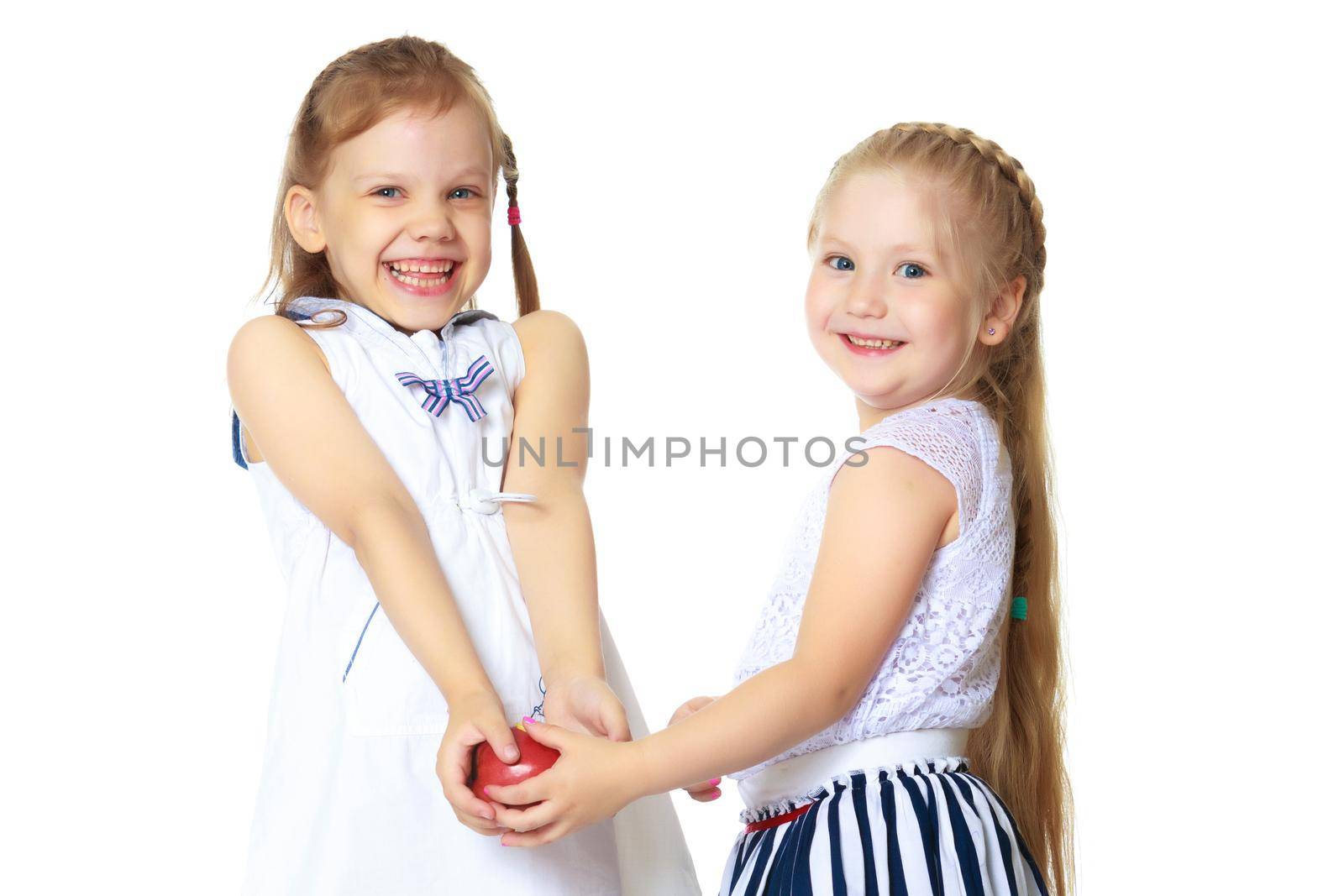 Two cute little girls close-up, in the studio on a white background. The concept of a happy childhood, Beauty and fashion. Isolated.