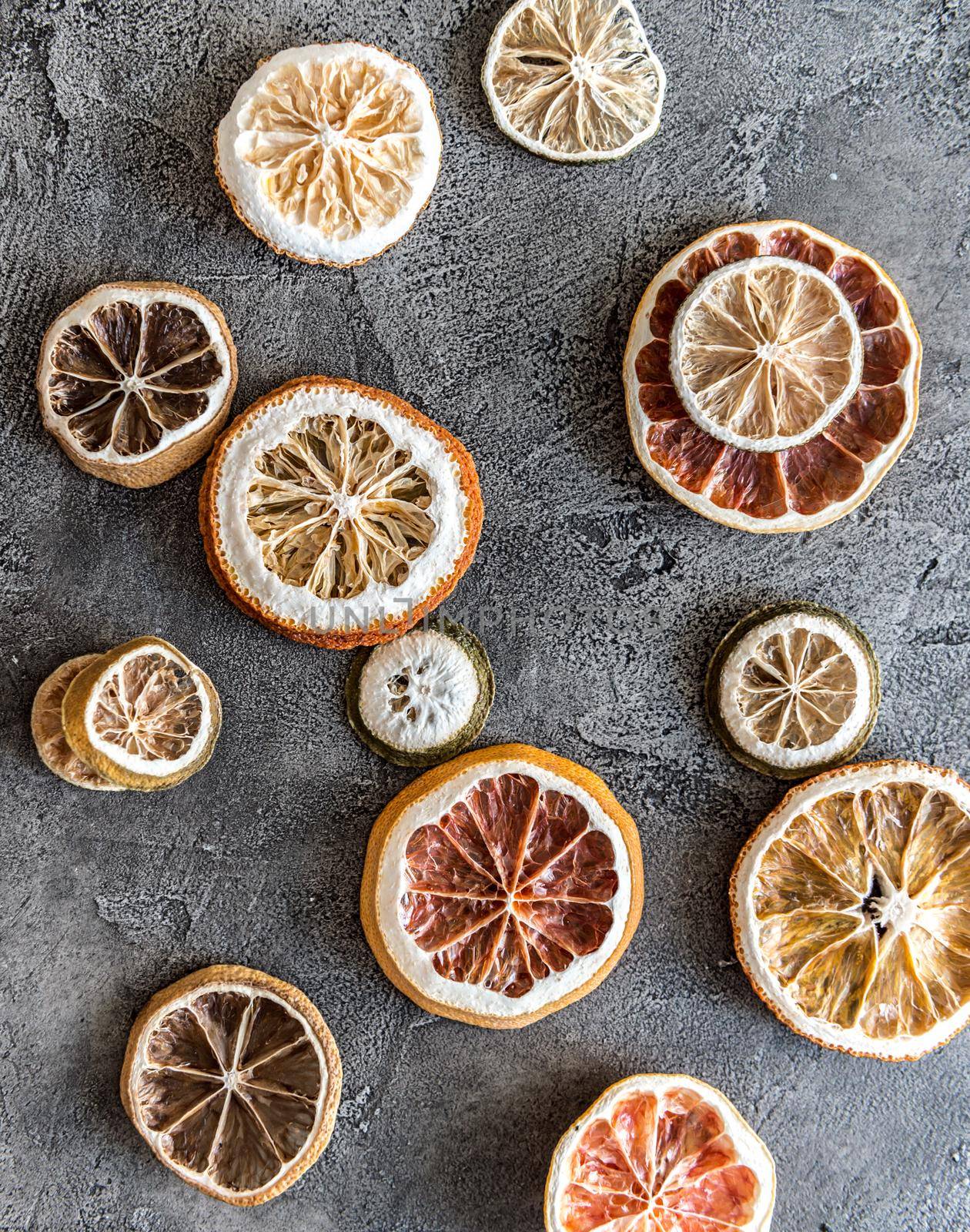 Pieces of dried oranges on a gray concrete background