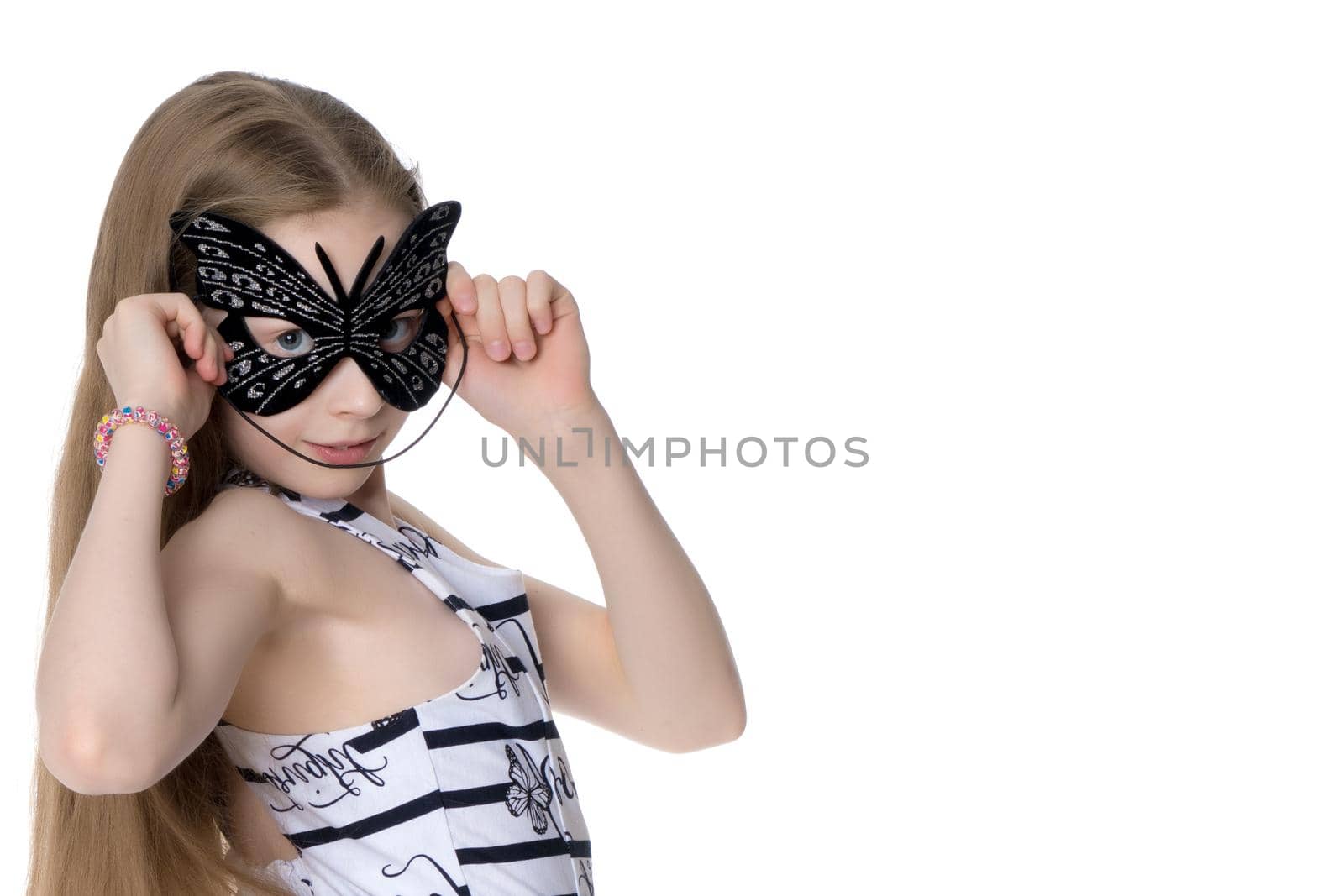 Beautiful little girl in the theatrical mask. Concept holiday, halloween, game. Isolated on white background.