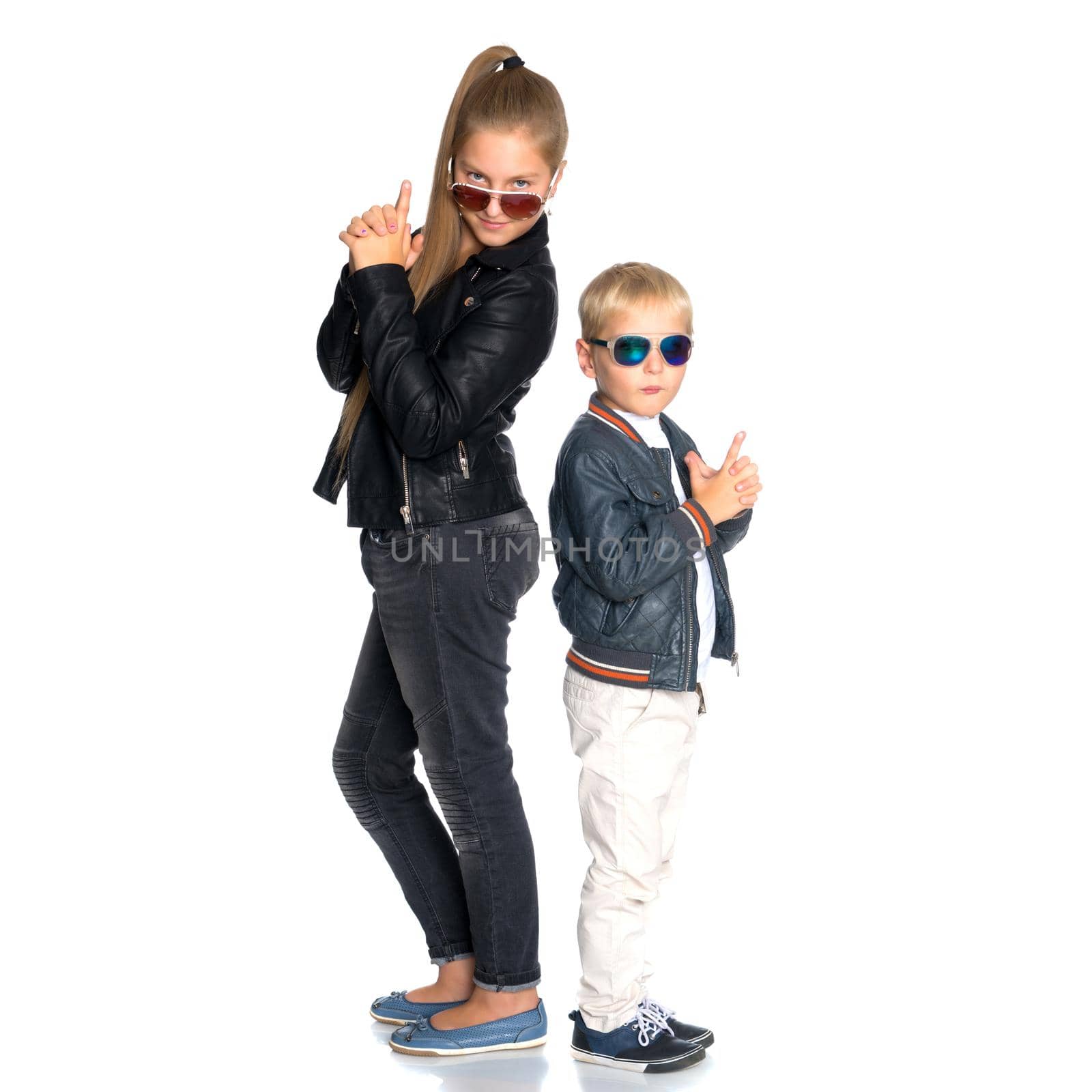 A teenage girl with her younger brother. studio photo session. The concept of family happiness.Isolated on white background.