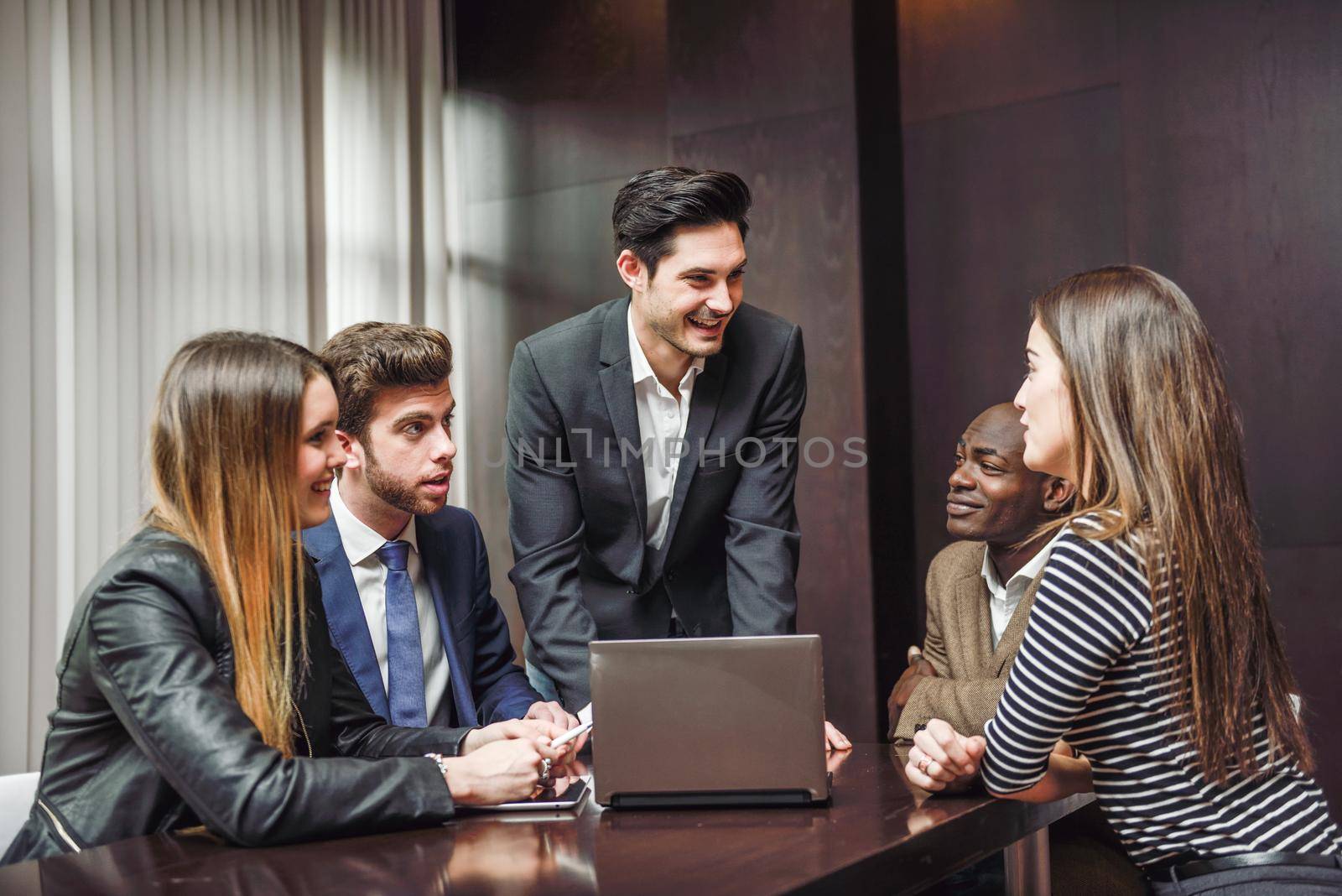 Group of multiethnic busy people working in an office by javiindy