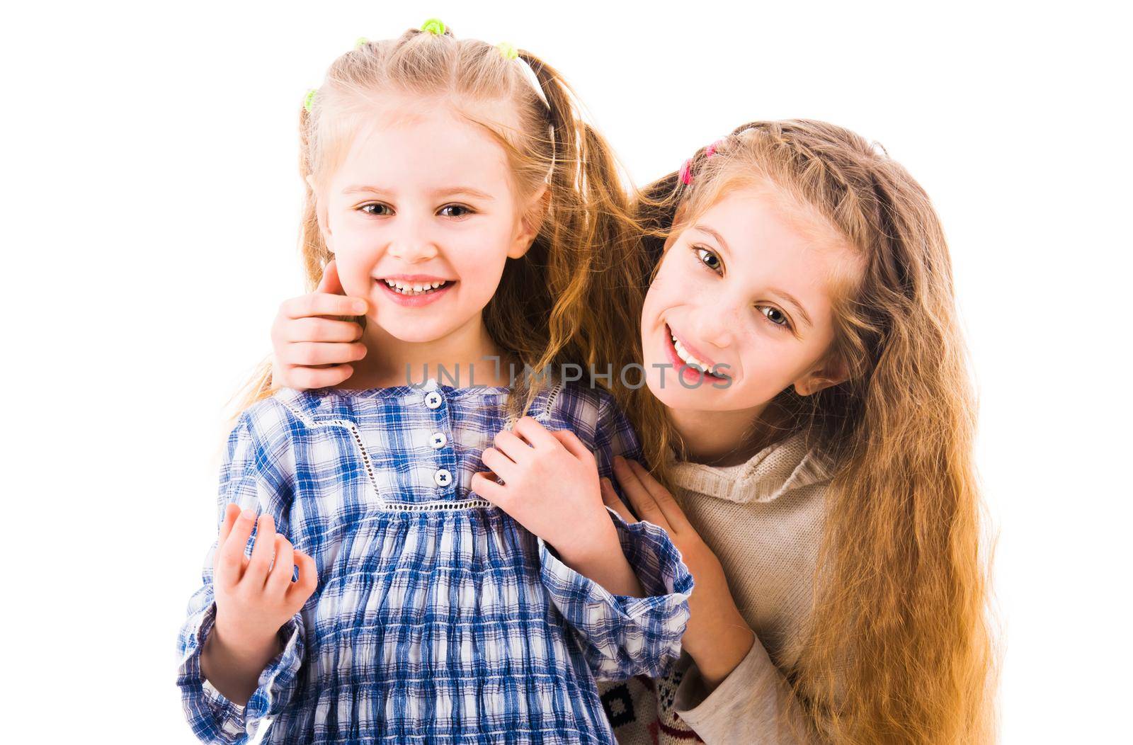 Two lovely happy girls playing and relaxing together isolated on white background. Two friends having fun