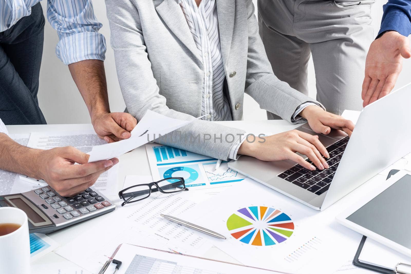 Corporate teamwork concept with businessmen. Secretary working with laptop Office desk with financial charts. Secretary working with laptop computer. Presentation and discussion of new startup project