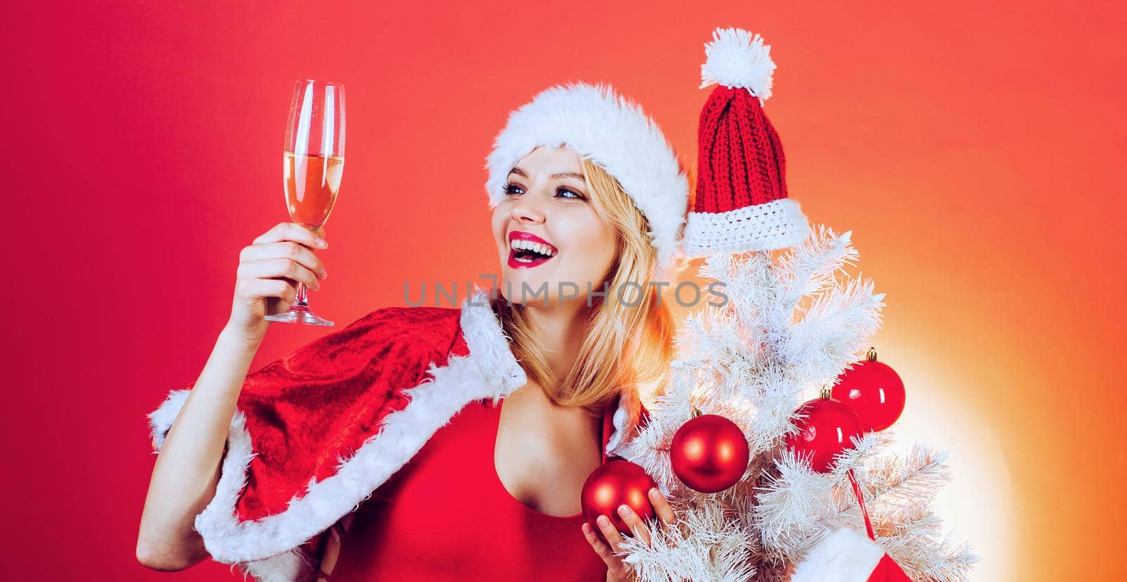 Happy girl preparing to celebrate new year and merry christmas. Celebration champagne. New Year celebration. Isolated, red background