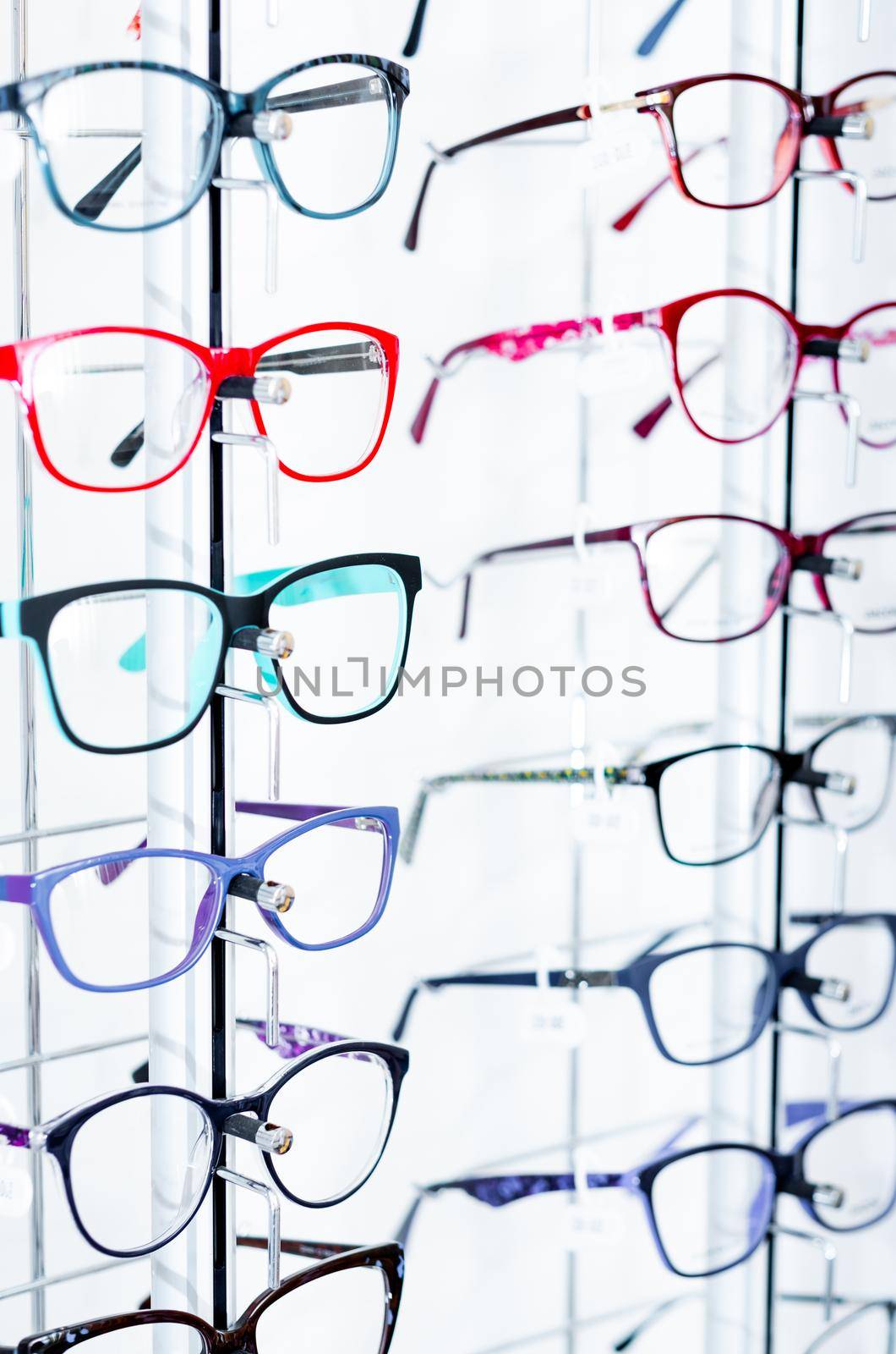 Closeup view of different colorful glasses for kinds on the showcase in the optical store