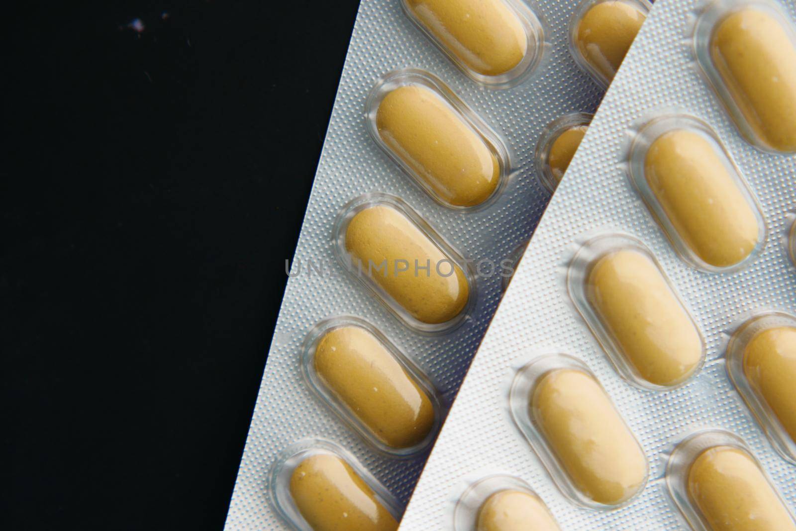Close up of pills of blister pack on table .