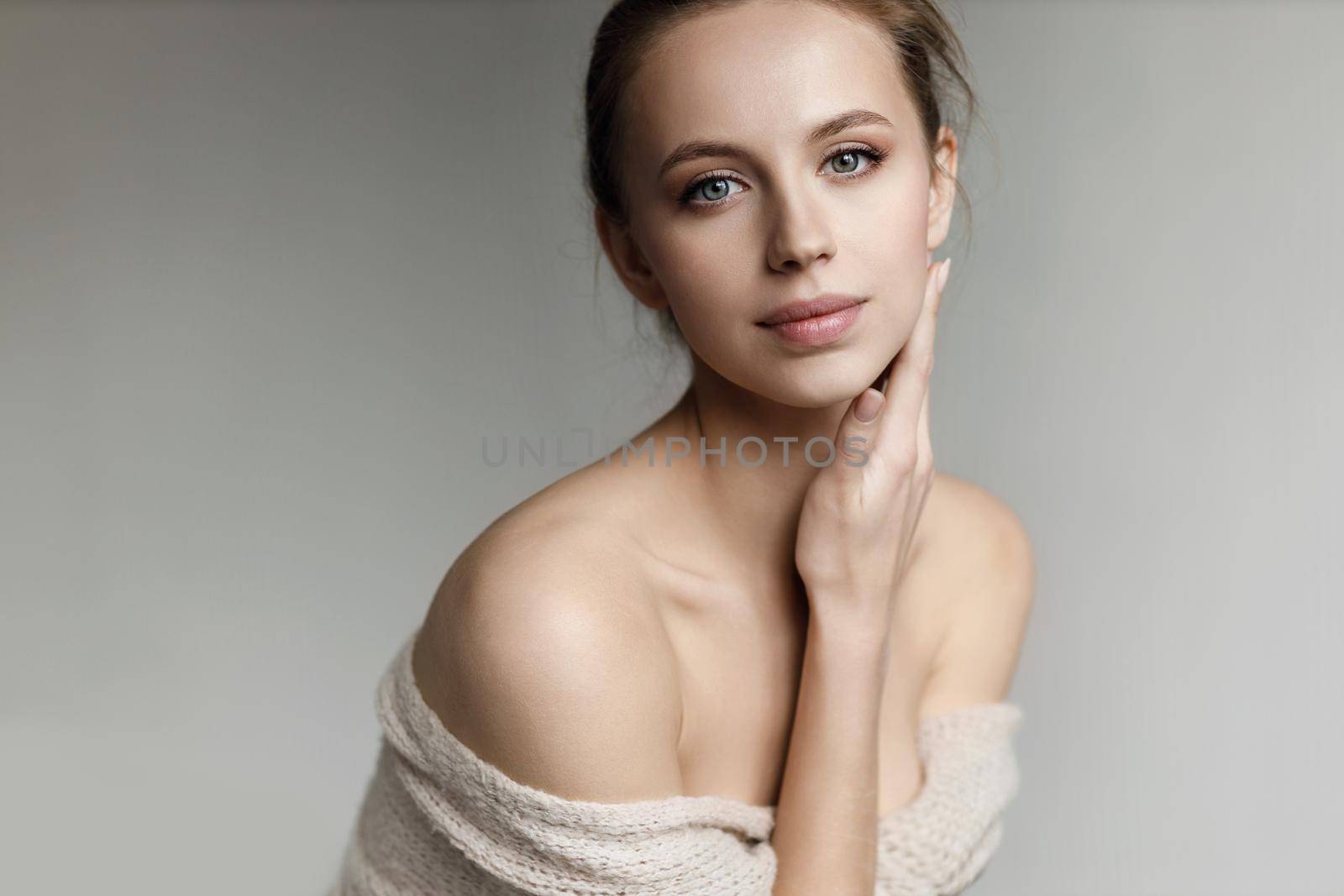 Portrait of a young pretty woman indoor in studio, skin wellness by splash