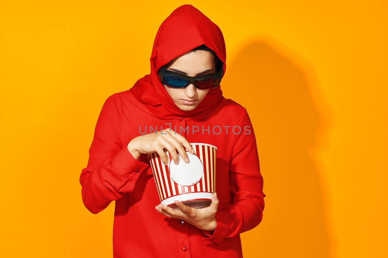 woman in red hijab virtual reality movie fashion fun movie isolated background. High quality photo