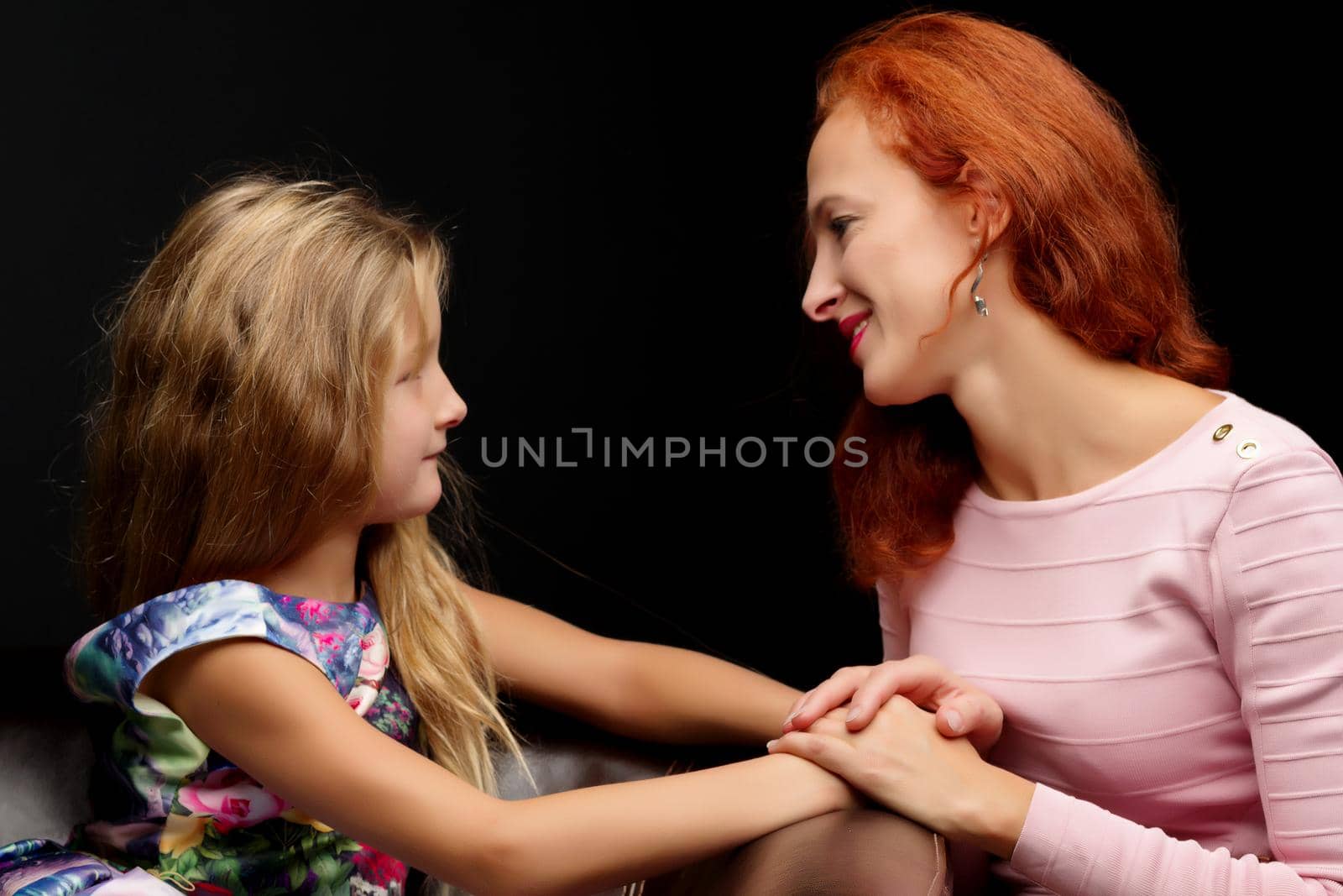 Young mother and little daughter gently embrace. The concept of Happy Childhood, Family Happiness, Raising a Child.