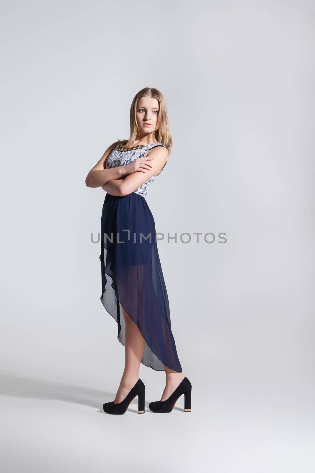Full Length Portrait of a Sexy Blonde Woman in Long Blue Fashion Dress