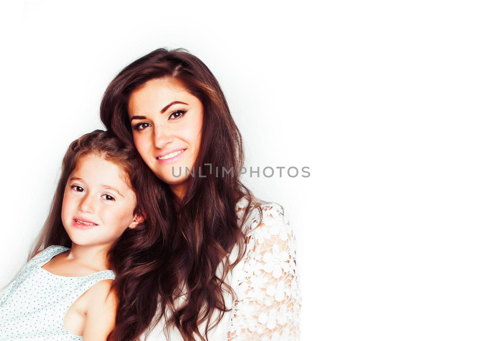 young mother with little cute daughter emotional posing on white, happy smiling family inside isolated adorable, lifestyle people concept close up