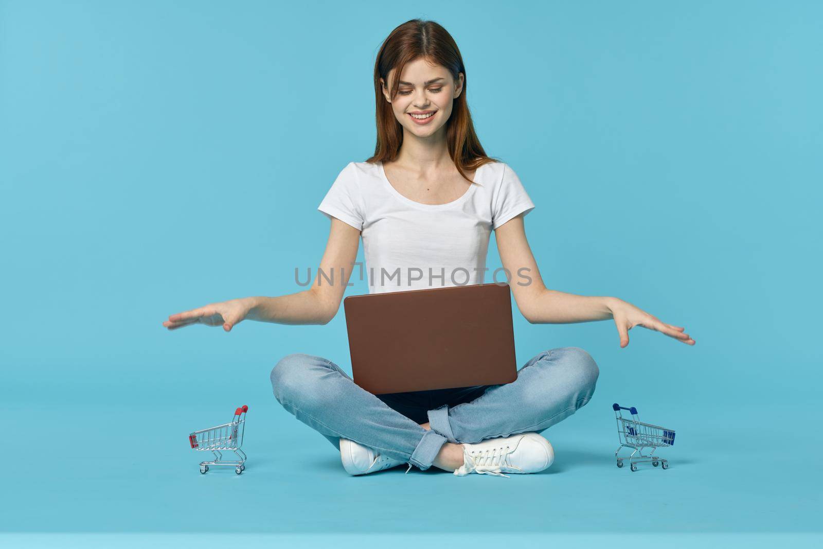 woman with laptop learning internet online education blue background. High quality photo