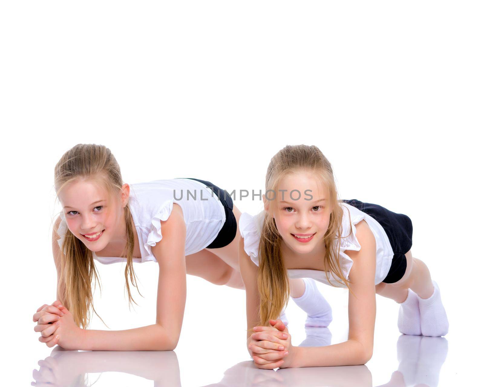 Girls gymnasts perform exercises. The concept of strength, health and sport. Isolated on white background.