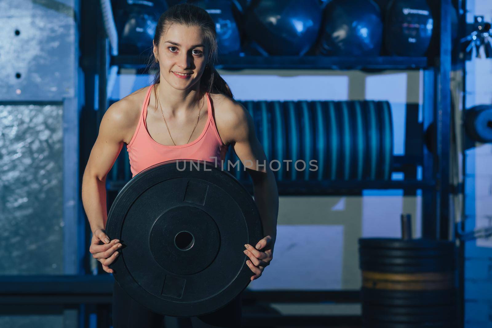 Muscular woman doing crossfit workout at gym.Crossfit woman. Crossfit style.