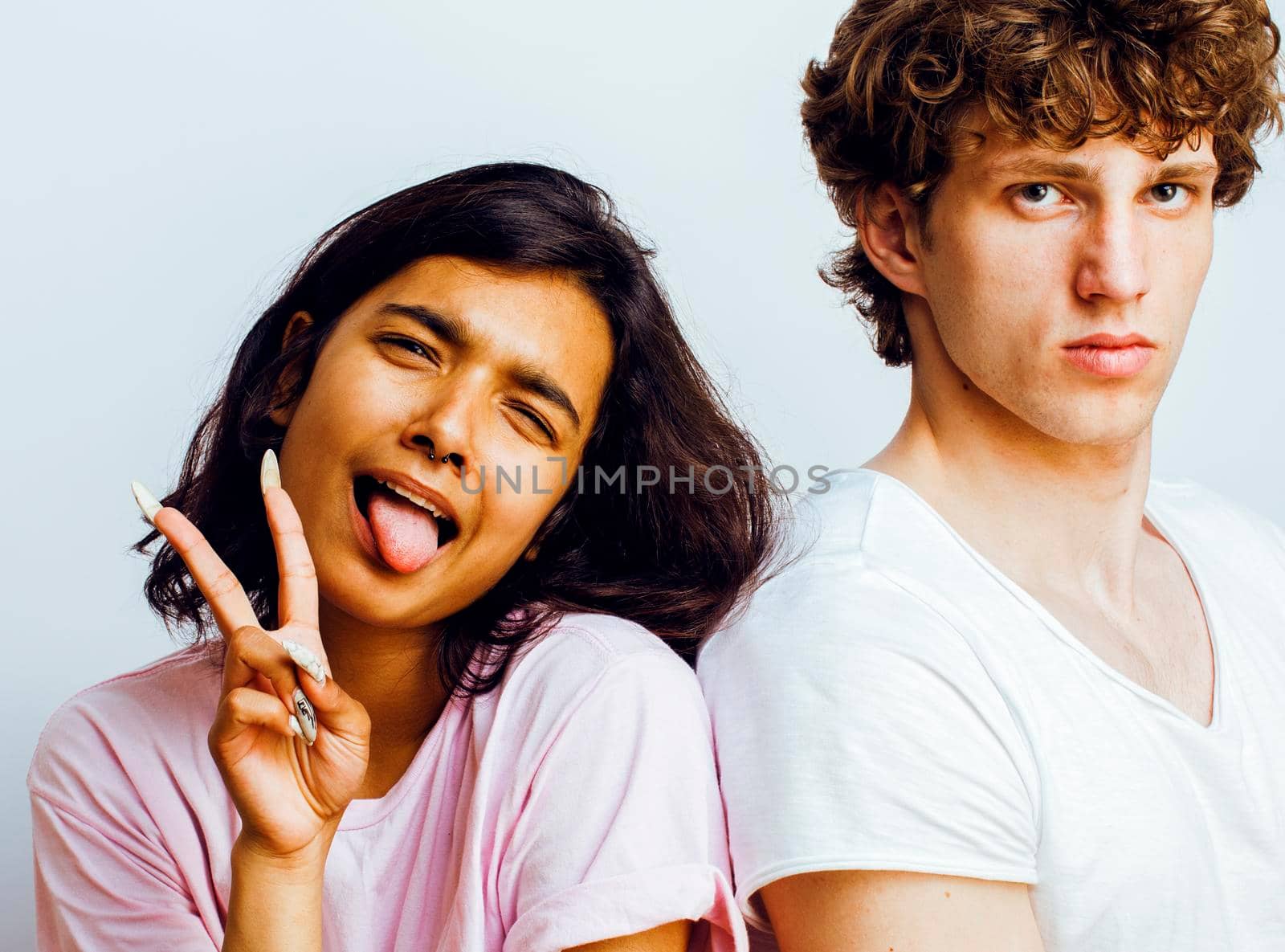 best friends teenage girl and boy together having fun, posing emotional on white background, couple happy smiling, lifestyle people concept, blond and brunette multi nations close up