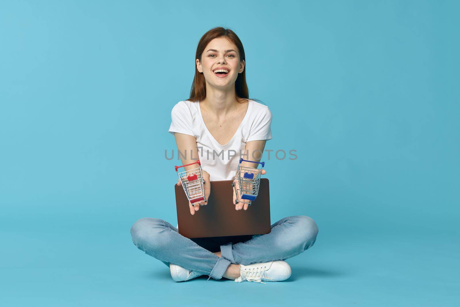 woman with laptop learning internet online education blue background. High quality photo
