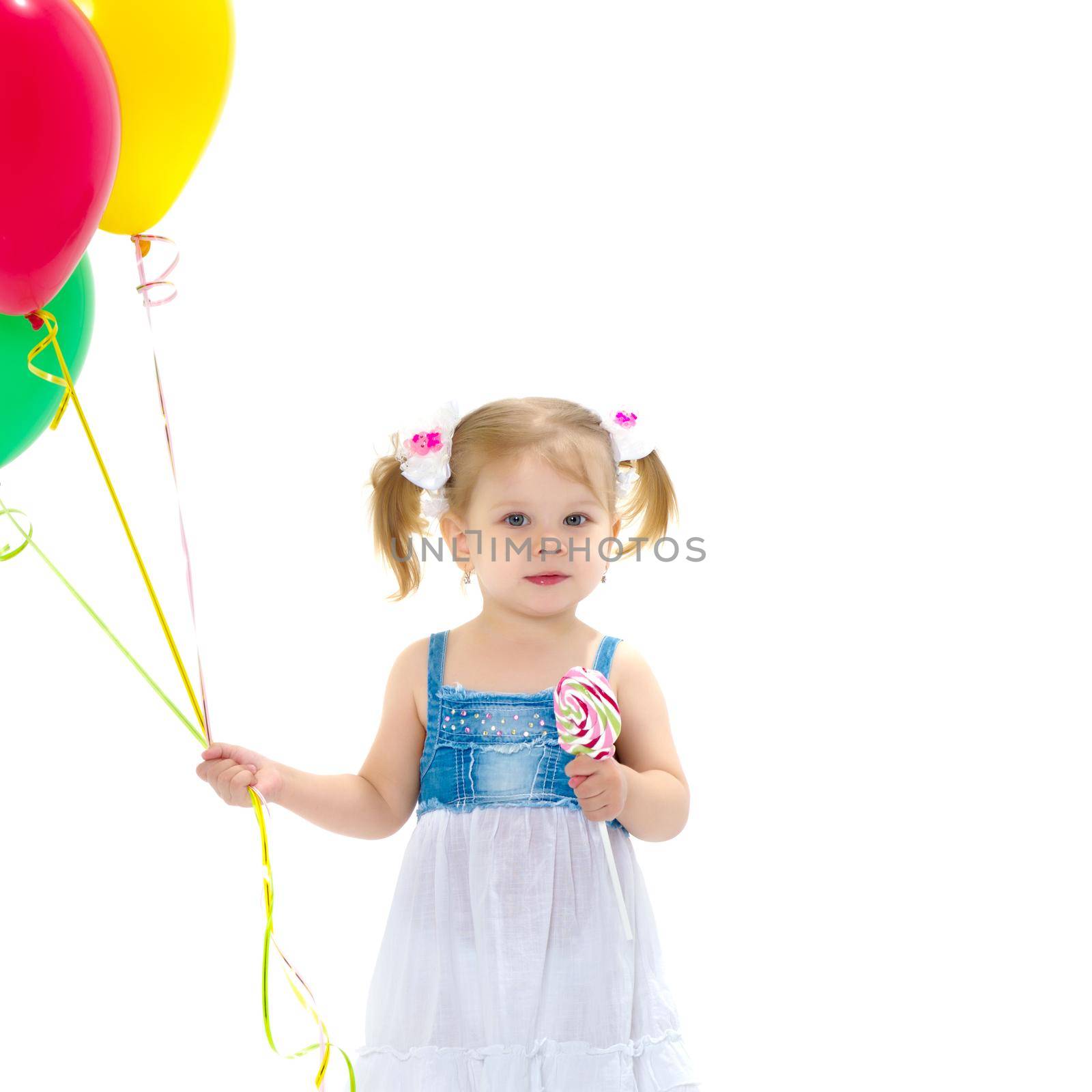 Little girl is playing with a balloon. The concept of the holiday, birthday. Isolated over white background