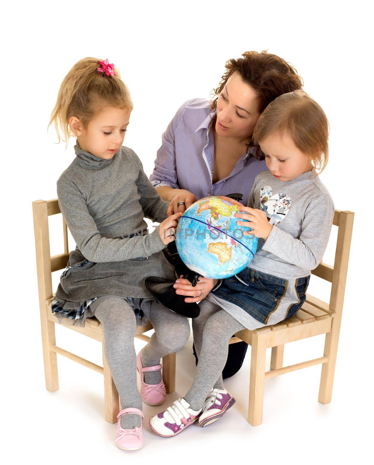 Young mother with her two daughters studying Globe - Isolated on white background