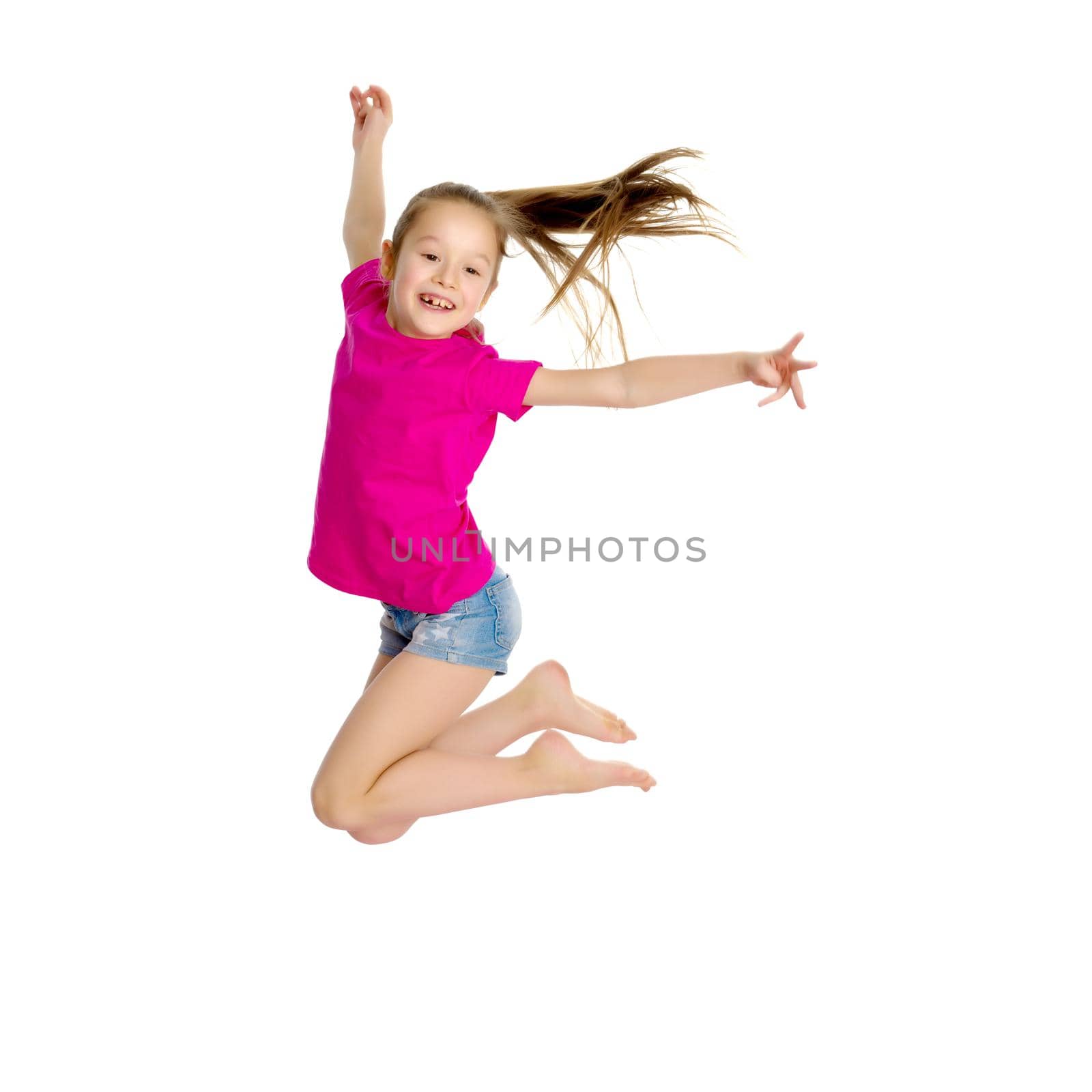 A little girl is jumping and waving her hands. The concept of a happy childhood, outdoor recreation. Isolated on white background.