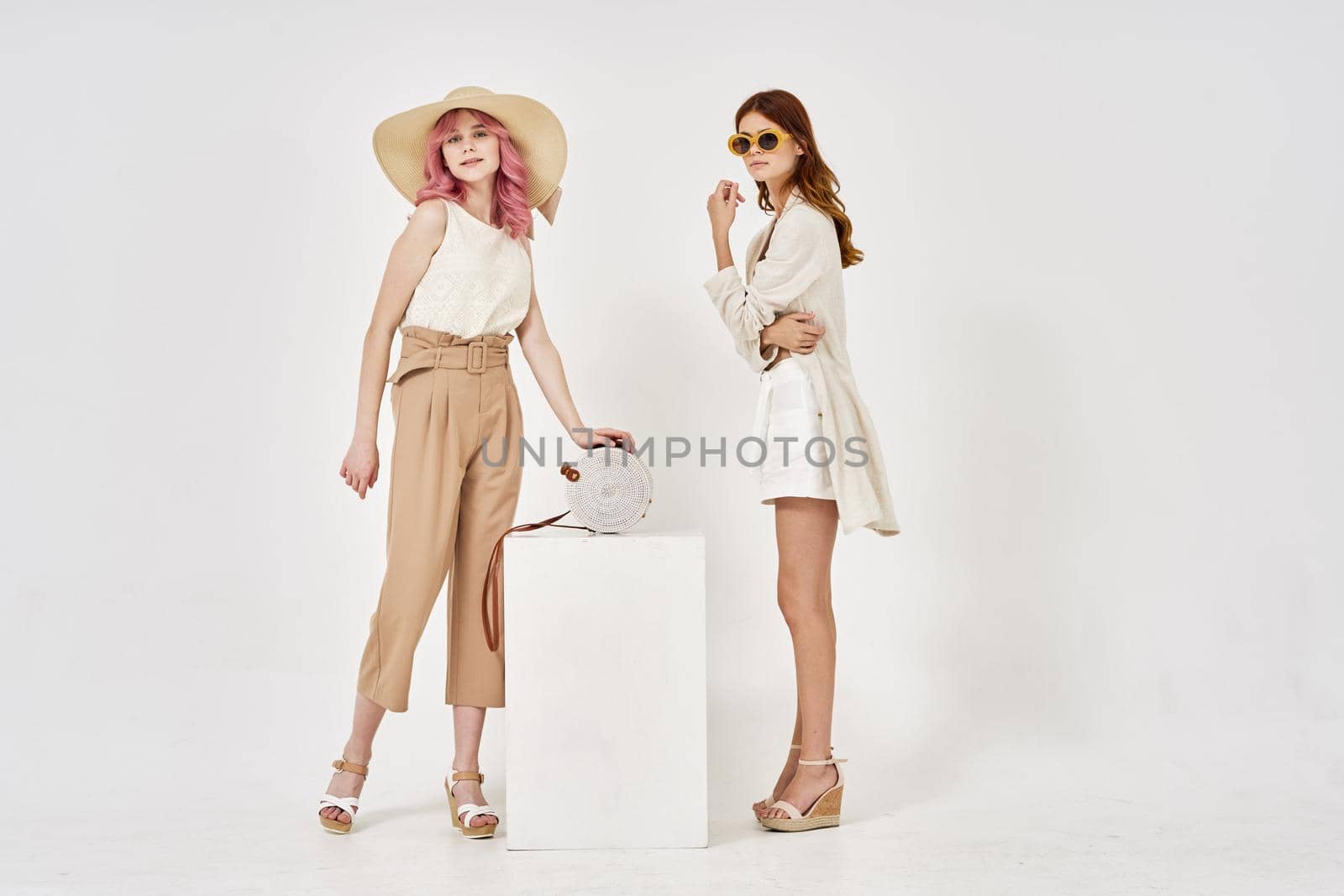 two women in fashionable clothes posing model decoration. High quality photo