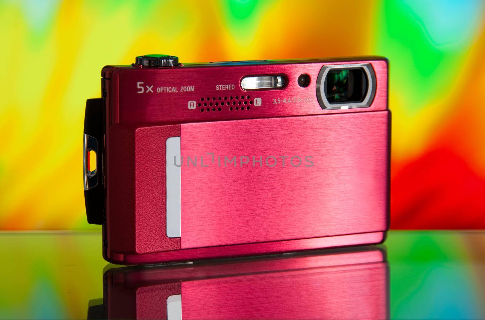 photo of the compact digital camera with beautiful background and glass reflection