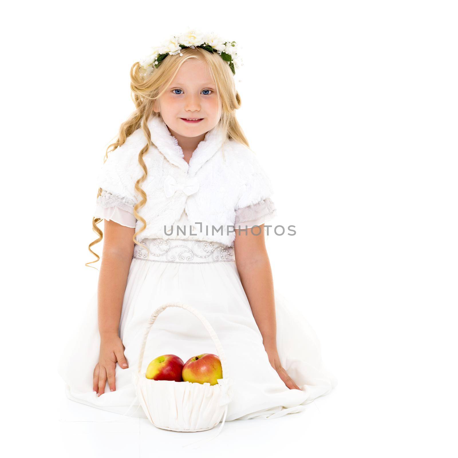 Little girl with a basket of apples. The concept of healthy eating, happy childhood. Isolated on white background.