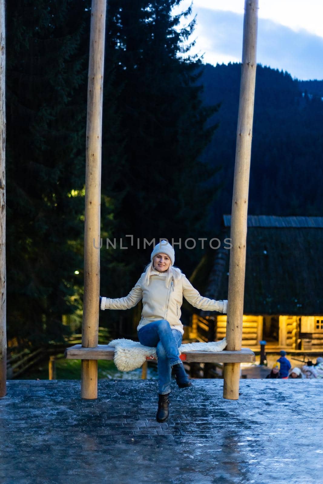 Caucasian woman sitting on swing. Concept of New Year inspiration and winter vacations