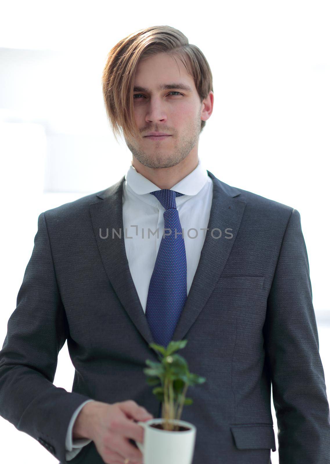 businessman with new sprout isolated on white.the concept of a startup