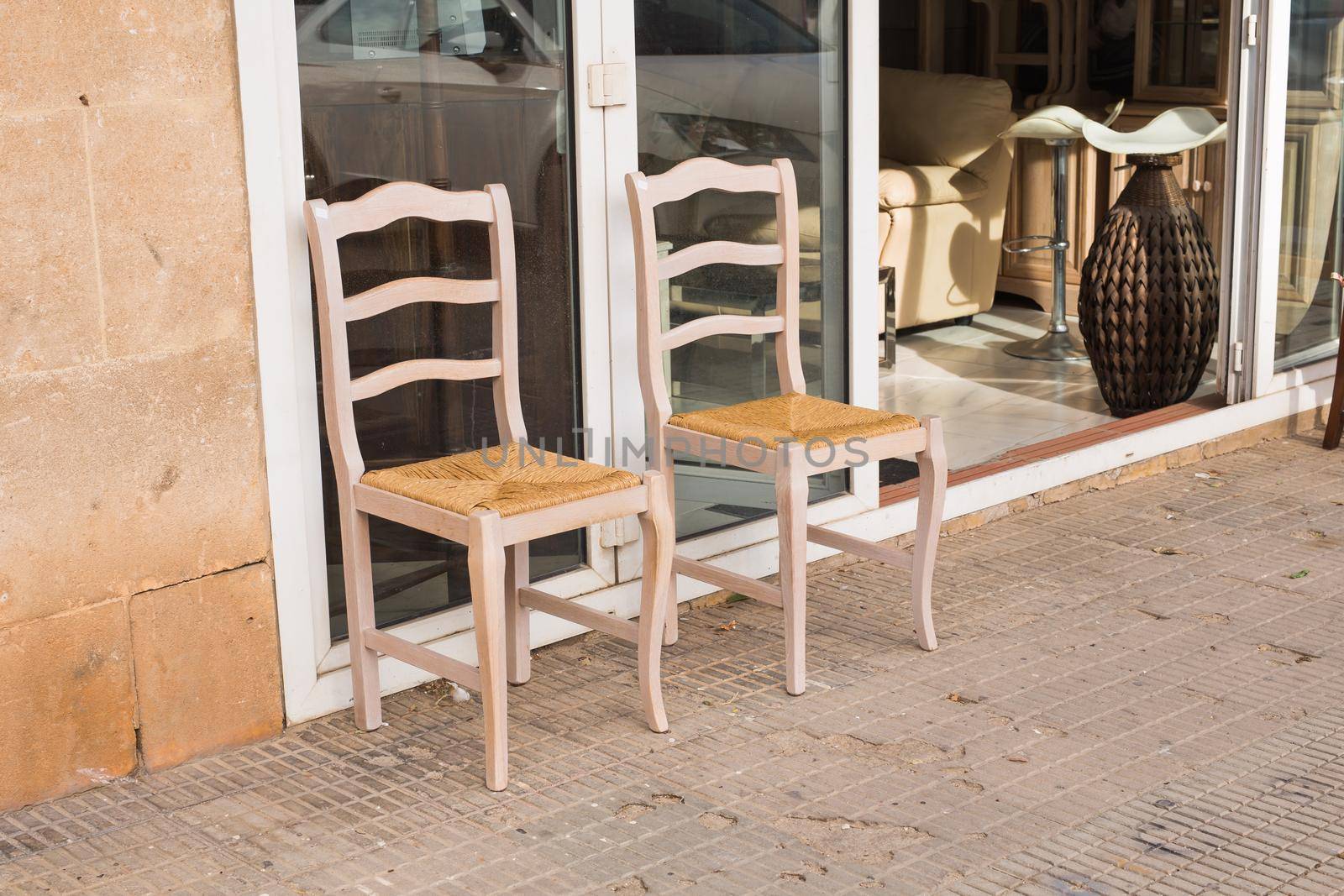 Two old wooden chairs standing on backyard.