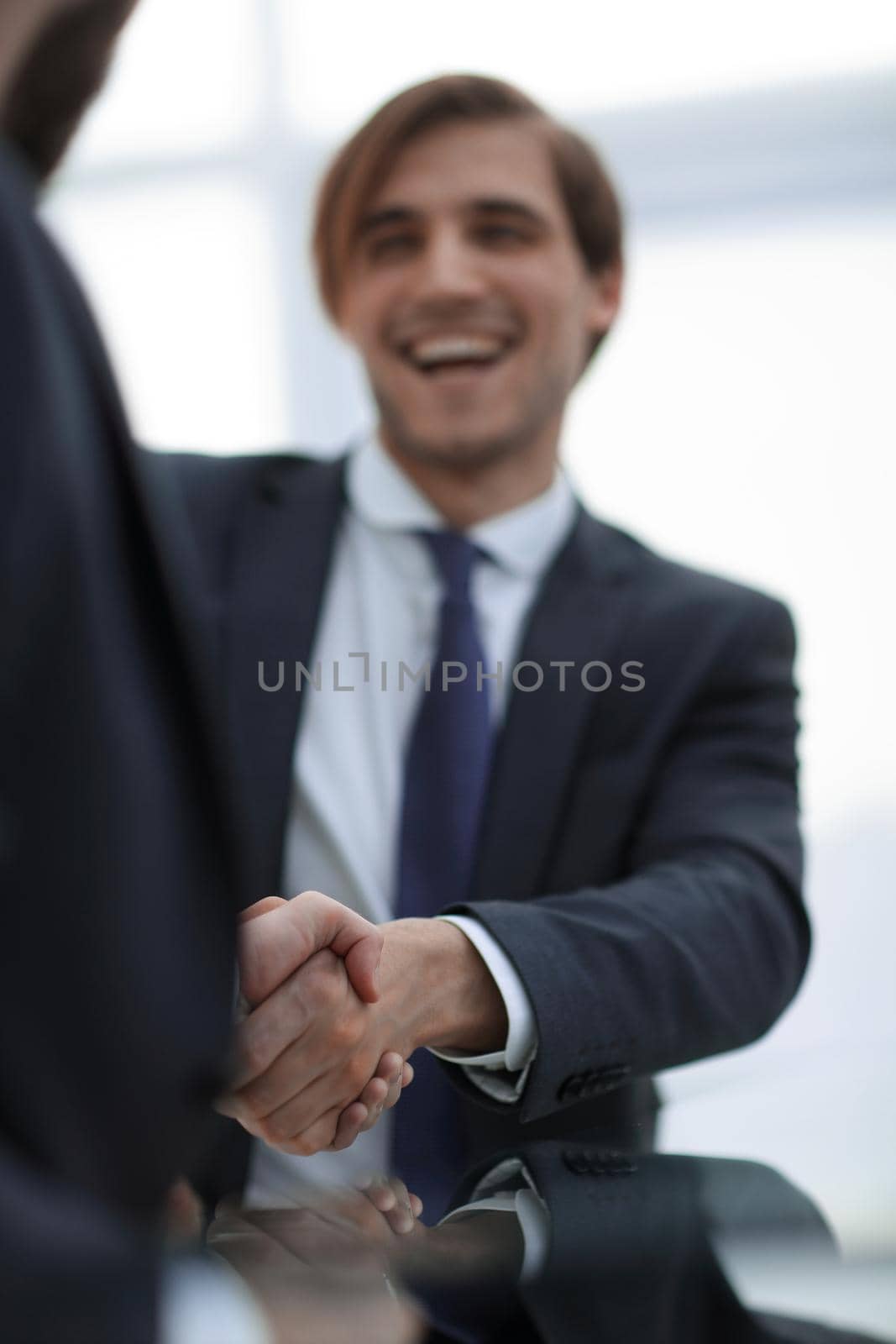 vertical photo.handshake business people .close up.