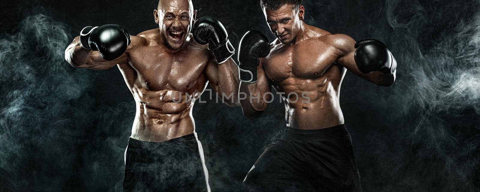 Street fighter fighting in boxing gloves. Isolated on black background with copy Space. Action shot. Sport concept.