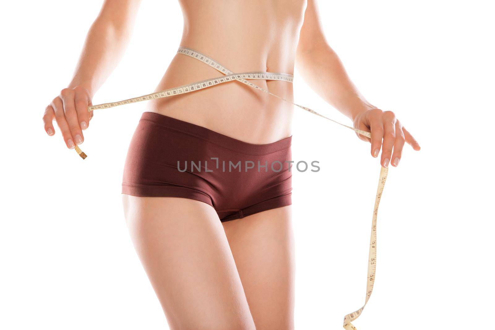 Woman measuring her waistline over white background