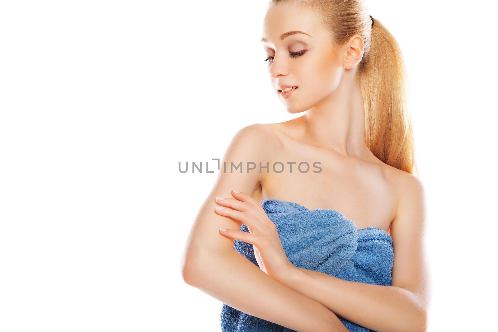 Portrait of the beautiful naked woman in a towel with body cream isolated