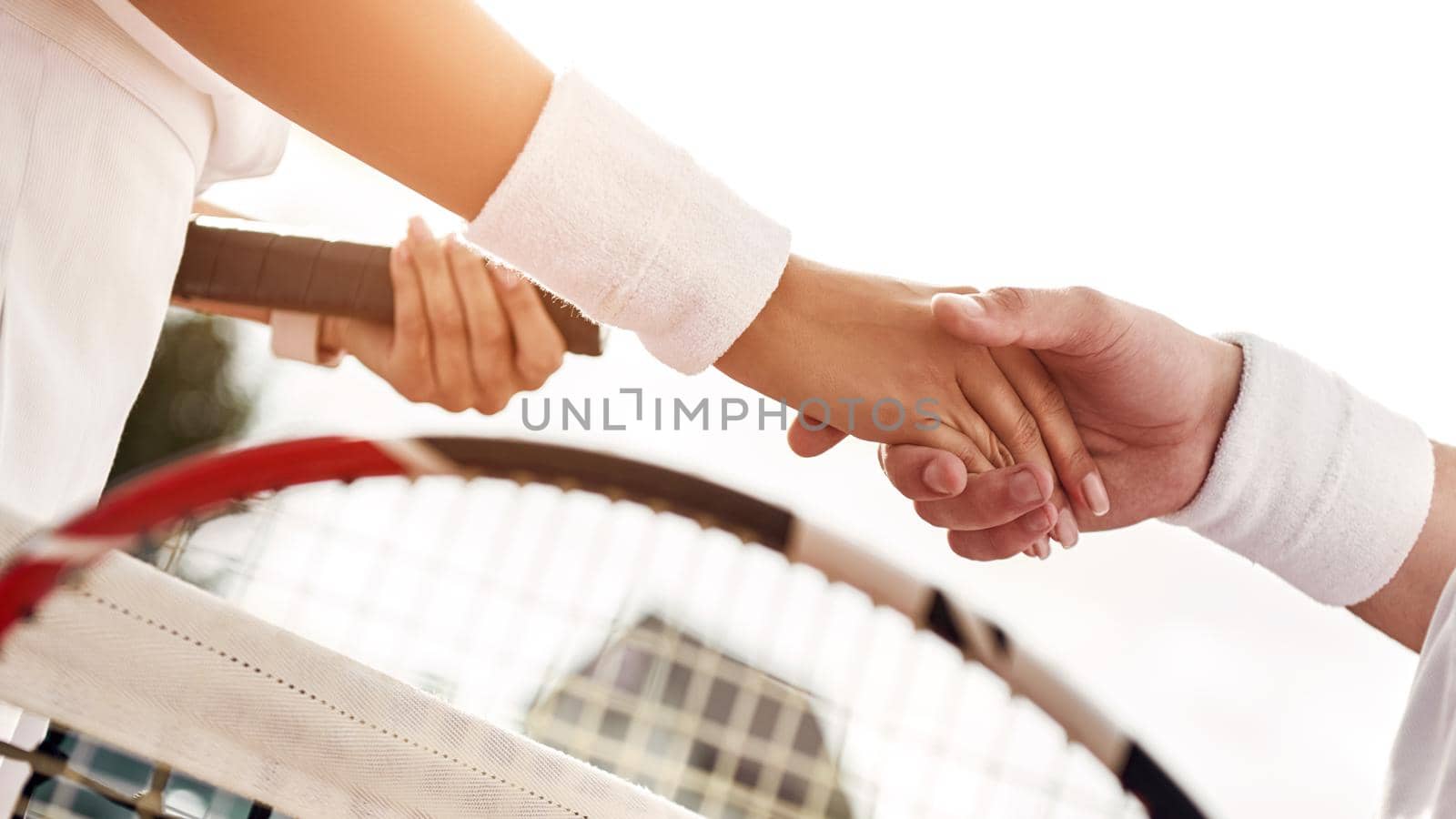 Woman and man shake hands with wristbands on it