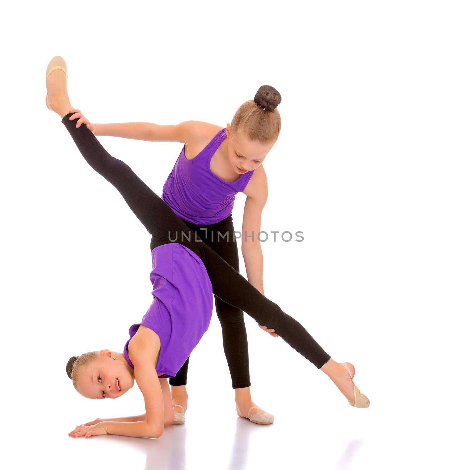 Girls gymnasts perform exercises. The concept of strength, health and sport. Isolated on white background.