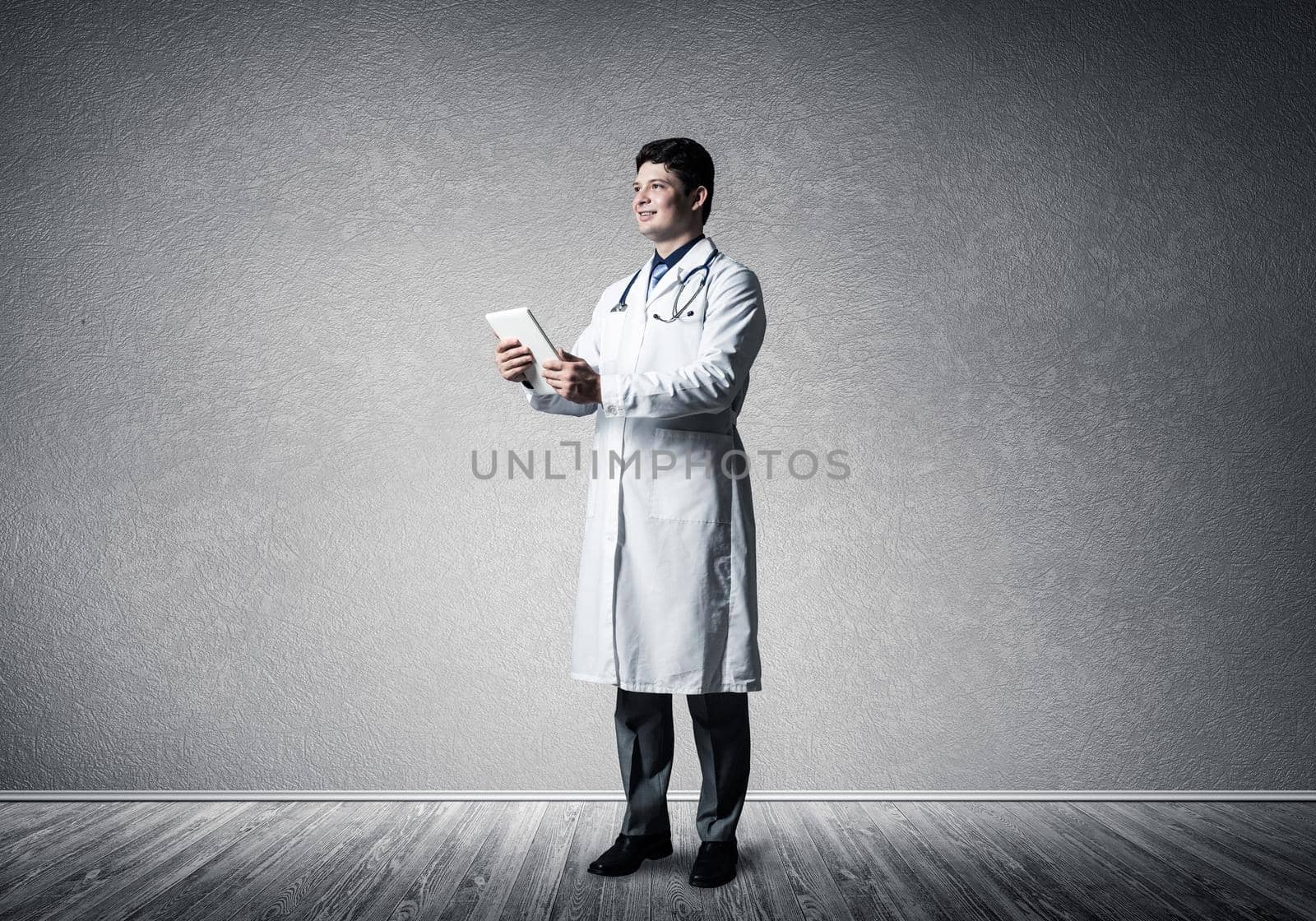 Doctor with a computer tablet. Full-length photography