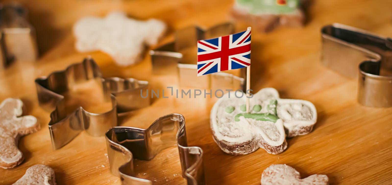 British holiday and Christmas baking concept. Union Jack flag of Great Britain and gingerbread men biscuits in the kitchen in England.