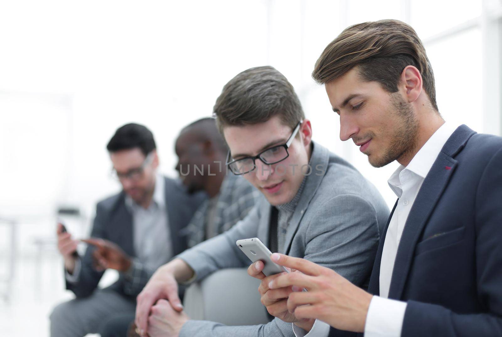 business colleagues reading SMS on smartphone by asdf