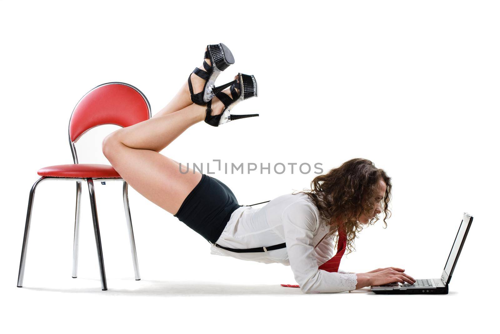 sexy young businesswoman lying on chair with laptop, isolated on white