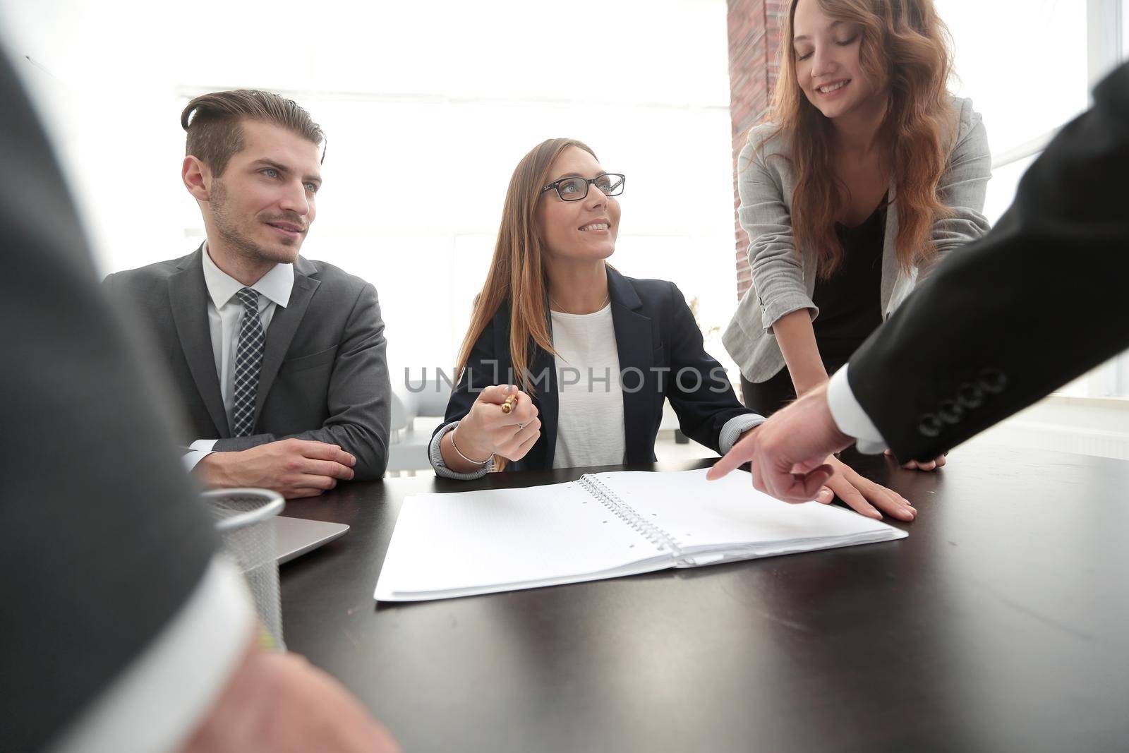 Businesswoman standing and leading business presentation.