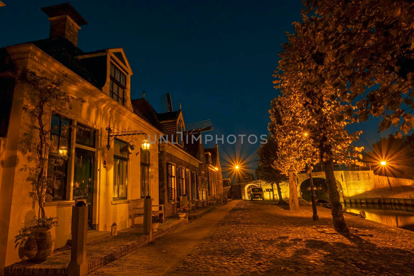 Historical houses in the city Sloten in the Netherlands at night by devy