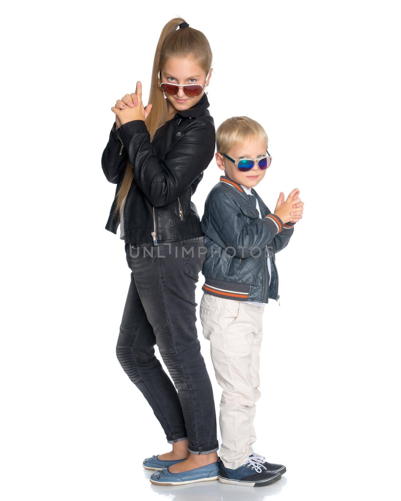 A teenage girl with her younger brother. studio photo session. The concept of family happiness.Isolated on white background.