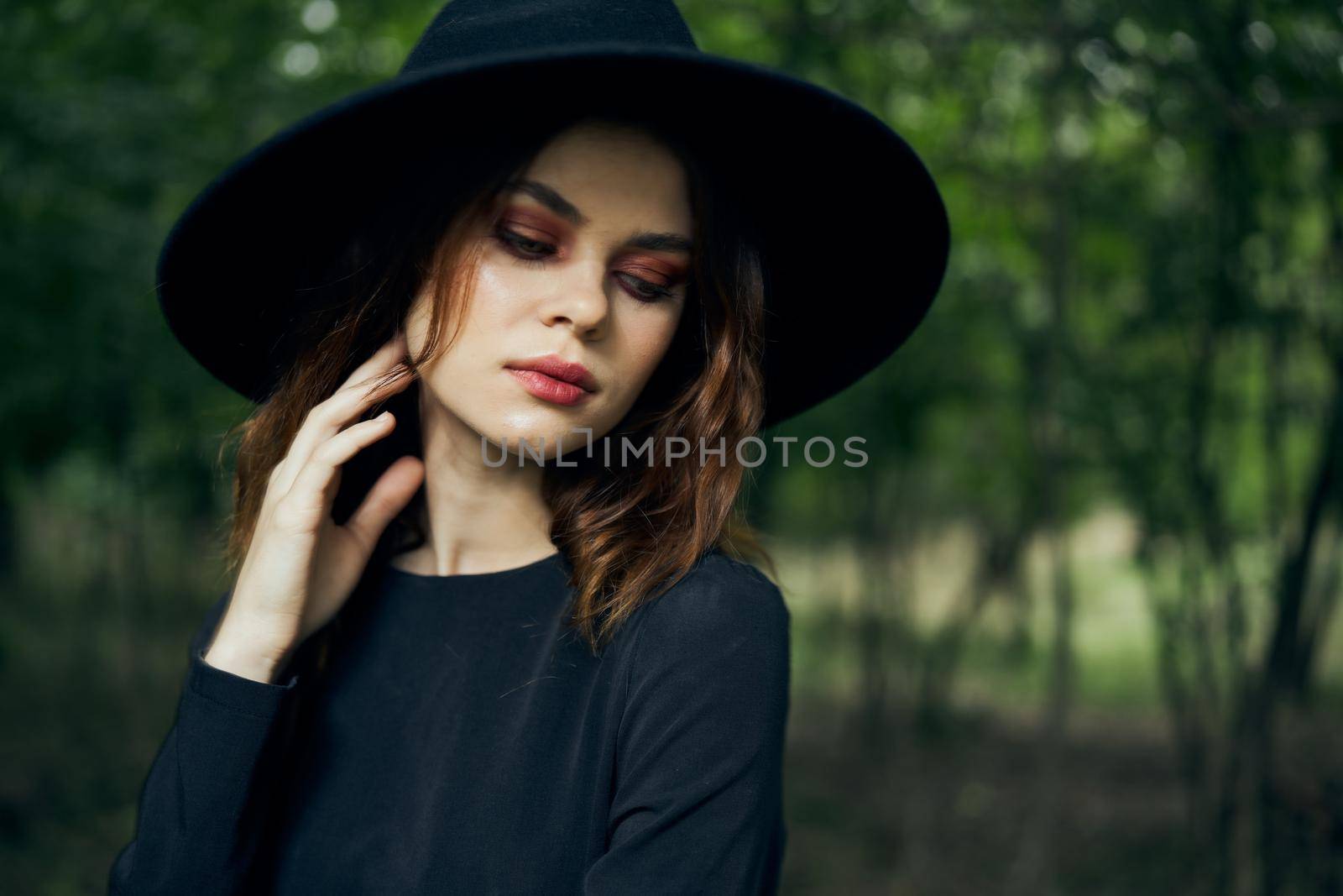 woman dressed as a witch in the forest Halloween fantasy ritual. High quality photo