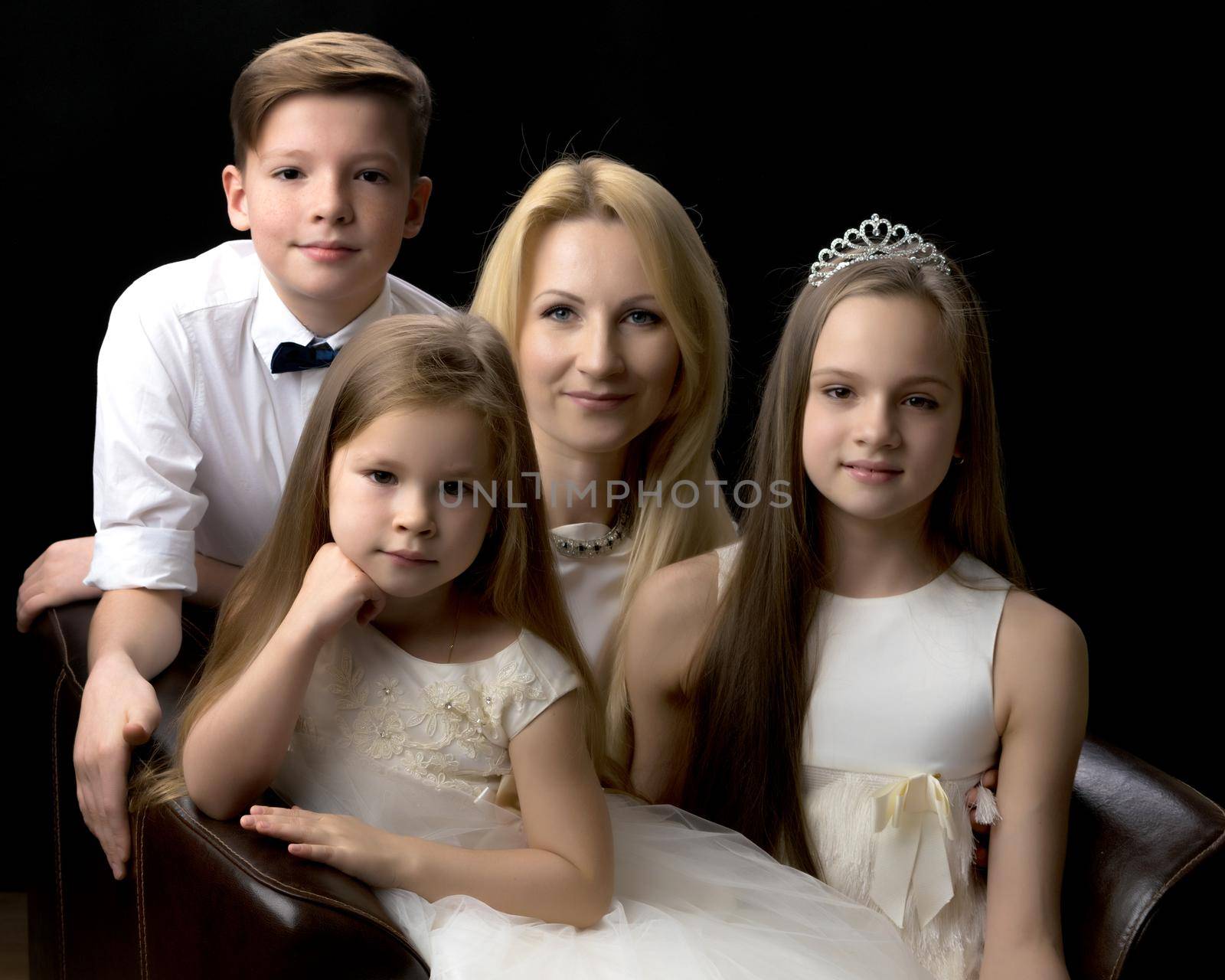 A happy mother with her favorite children. The concept of happy motherhood, childhood, beauty, people, family.
