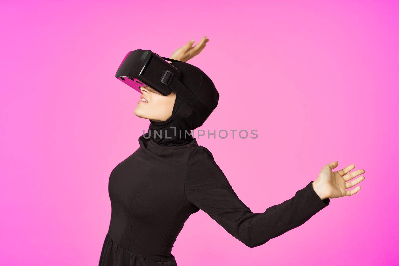woman in black hijab glasses virtual reality technology movie watching. High quality photo