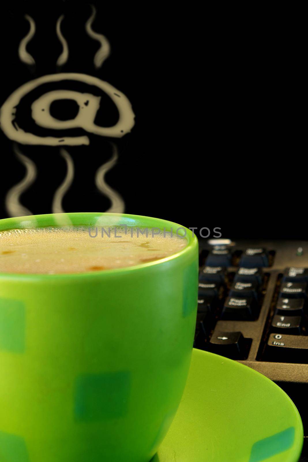 green cup of coffee and pc keyboard